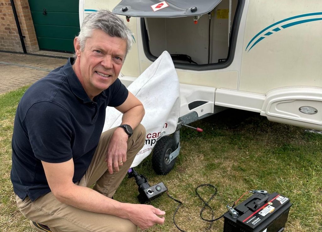 Caravan servicing looking at camera, lightbulb test